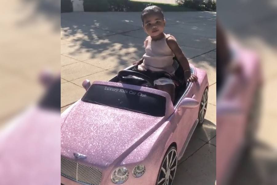 Khole's baby in a Bentley Convertible