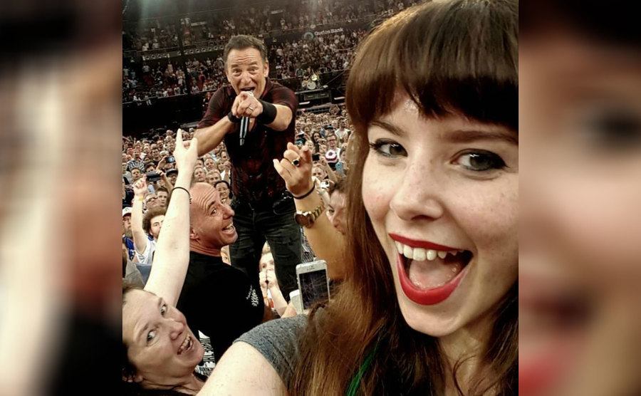 Bruce Springsteen in the background of a selfie singing 