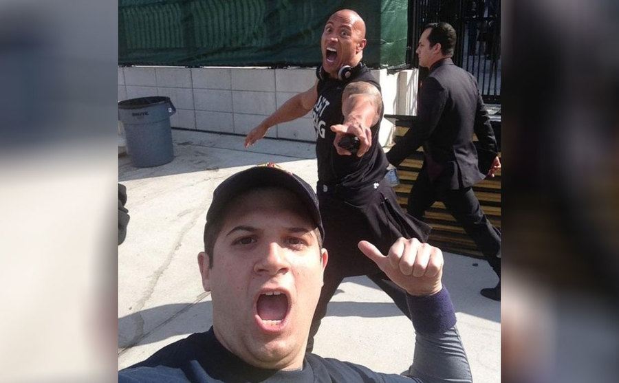 The Rock in the background of a selfie 