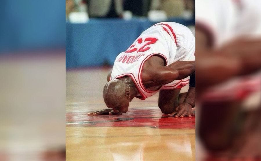 Michael Jordan kissing the floor on the court before a game 