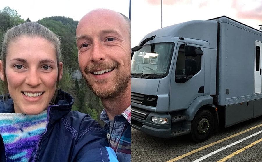 A grey truck / Iona and Martin in front of the mountains covered in trees 