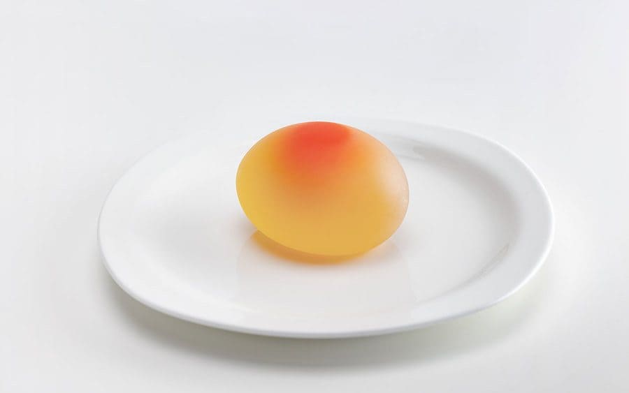 An egg without the shell after it is soaked in vinegar 