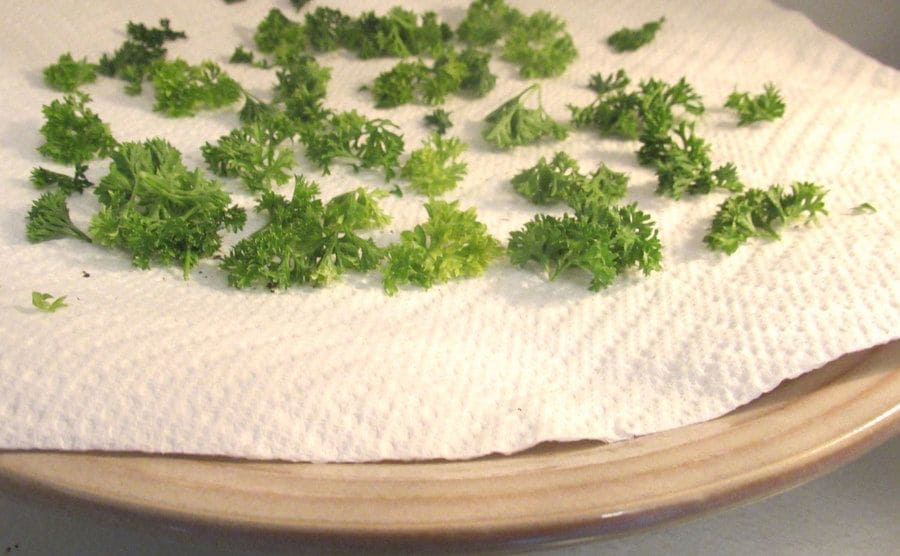 Herbs being dried in a microwave