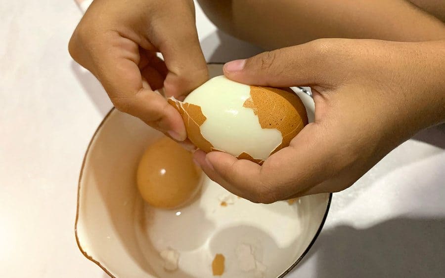 The shell being removed from a boiled egg