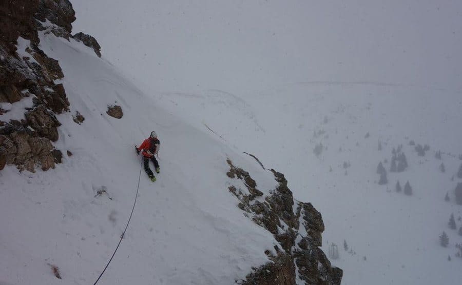 Matt climbing the side of Everest attached to a rope 