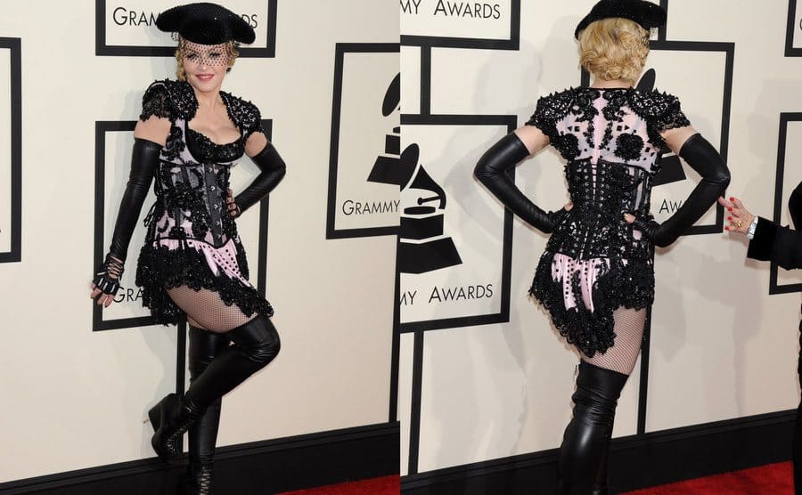 Madonna in a short lace pink and black corset dress with shiny black shoulder pads fishnets, open-toed thigh-high boots, and a matador hat with a veil. / The back of Madonna's dress showing the corset tied up and a pink bow on the bottom.