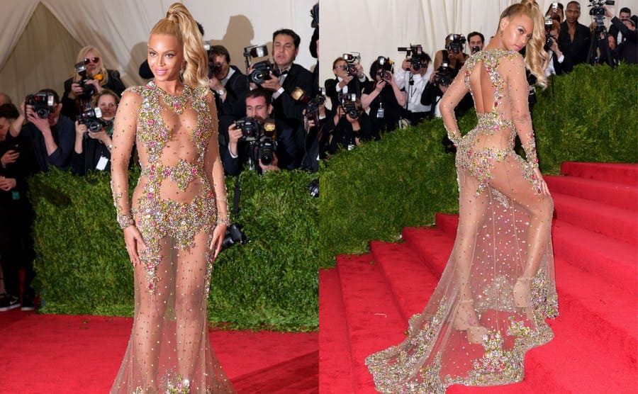 Beyoncé in a long sheer dress with gold accents covering inappropriate parts of the body and a long train. / The back of Beyoncé's dress with the same gold accents covering her behind. 