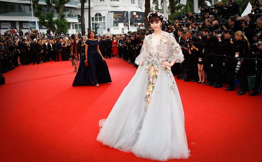 Fan Bingbing wearing a long floral pastel blue gown with a crown made with flowers 