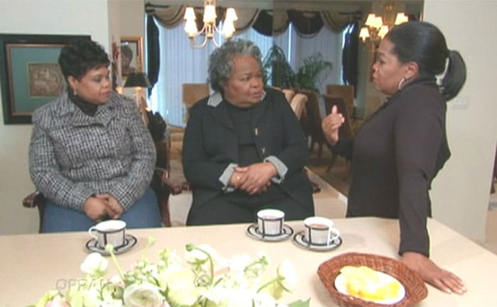 Patricia, Vernita, and Oprah sitting around a kitchen island with tea 