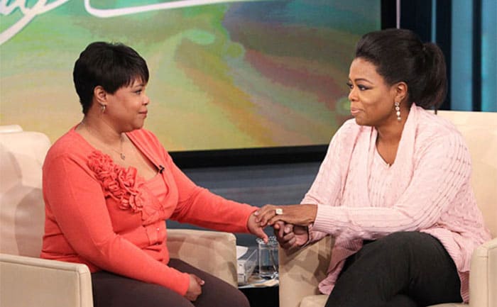 Patricia and Oprah holding hands on her talk show 