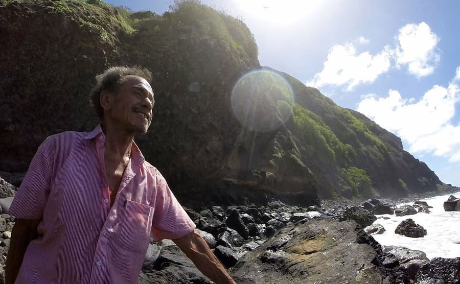 Kolo Fekitoa standing on the rocky shore of Ata Island 