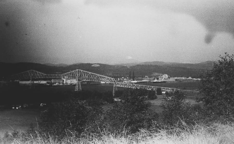 A photograph of the Lewis and Clarke bridge with a bit of smoke in the distance 