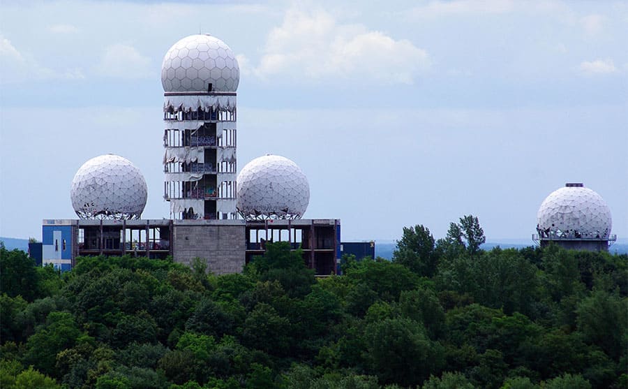 The Teufelsberg Listening Station, with one building, three large ball-shaped pieces coming out of it and a fourth one to the right of the building