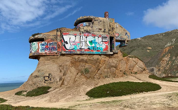 The Devil’s Slide bunker sitting on a large rock covered in graffiti 