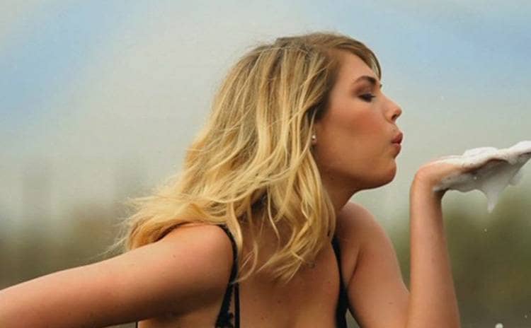 Kate Upton blowing soap bubbles off of her hand in a Mercedes-Benz commercial 