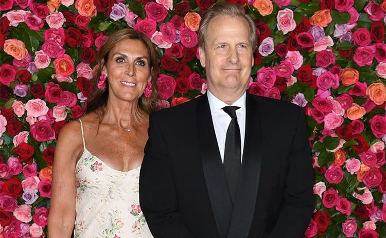 Kathleen Treado and Jeff Daniels in front of a wall of roses