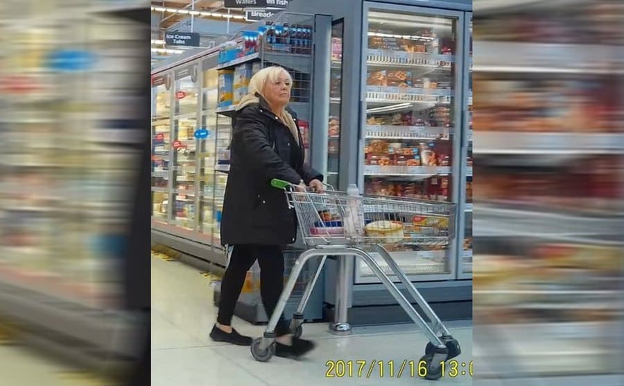 Christina at the supermarket walking with a shopping cart 