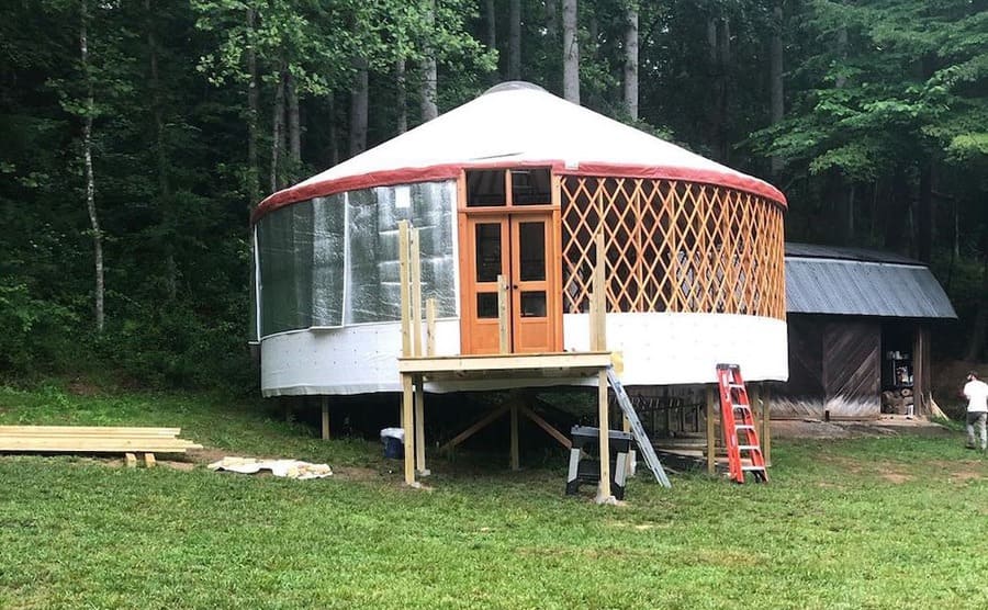The yurt with the lattice siding and a half-built deck 