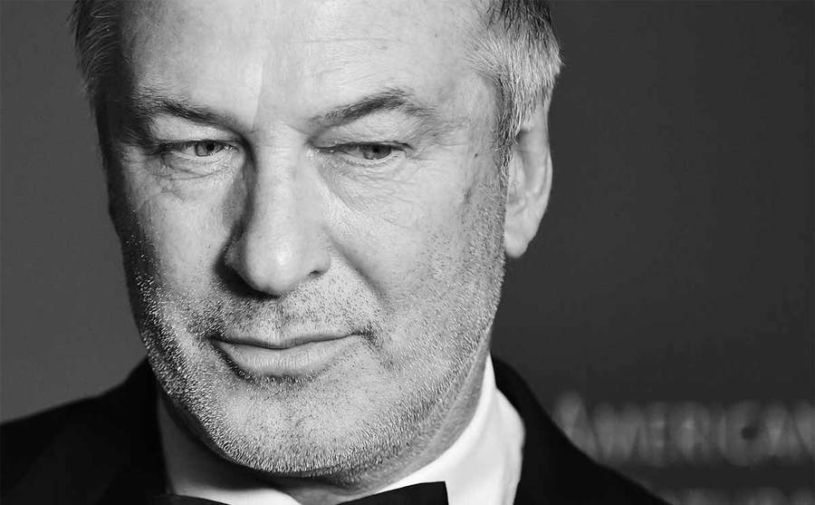 A close-up photograph of Alec Baldwin’s face while he is dressed up on the red carpet 