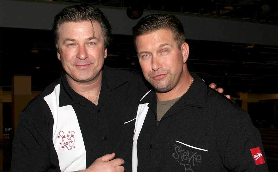 Alec and Stephen Baldwin wearing bowling shirts at a stage theatre’s bowling event 