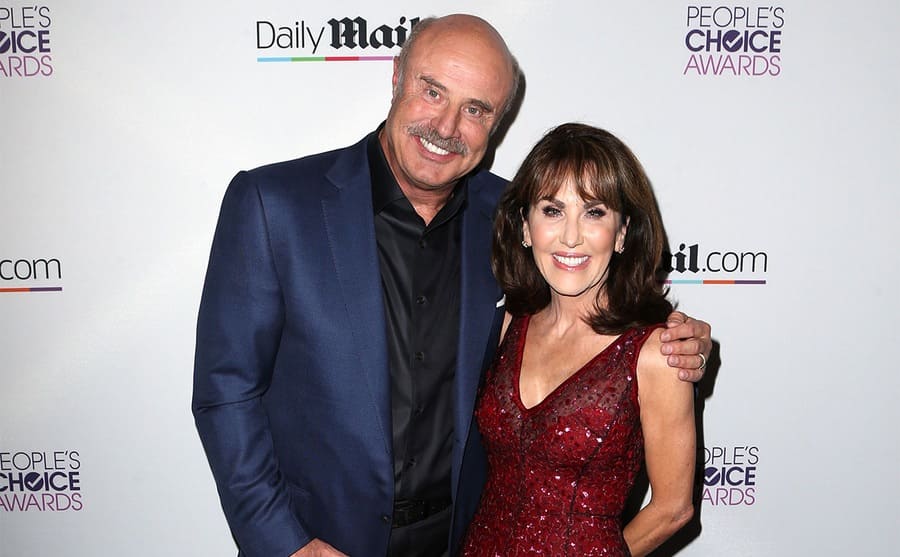 Dr. Phil and Robin posing together on the red carpet 