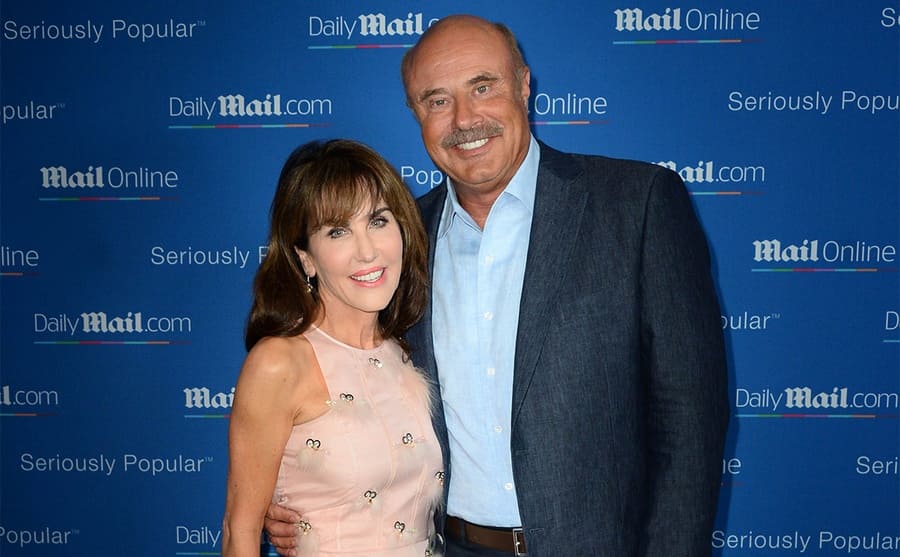 Robin and Dr. Phil posing on the red carpet in 2015