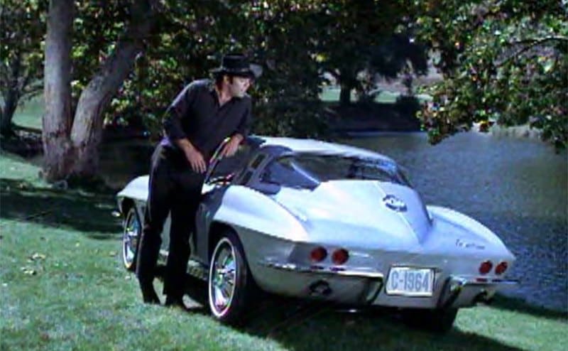 Pernell Roberts standing by a Chevrolet in an old commercial 