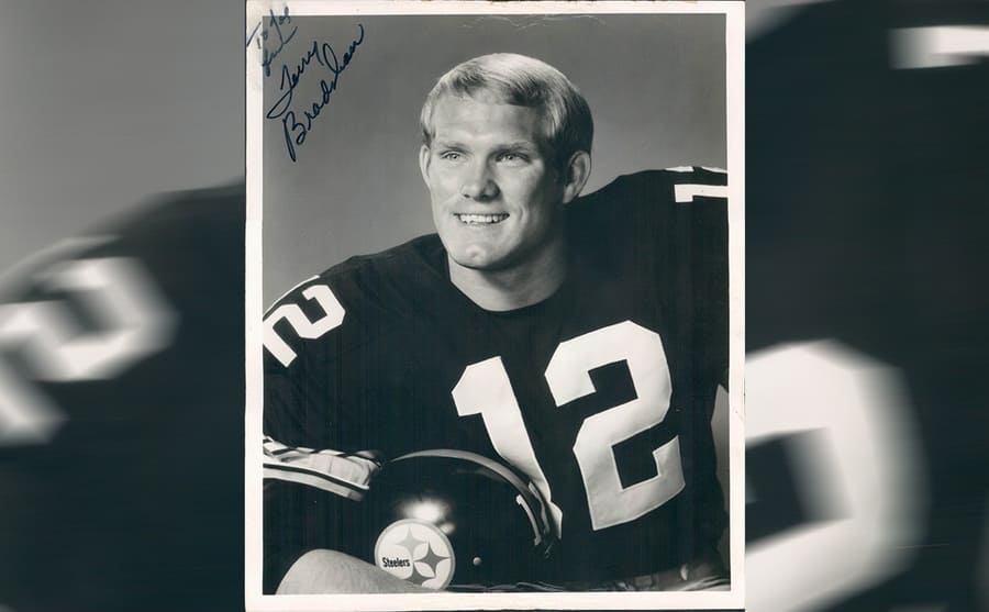 Autographed black and white image of Terry Bradshaw in his football uniform 