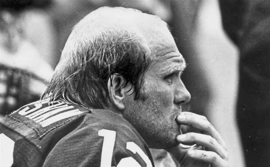 Terry Bradshaw contemplating on the sidelines during a game in the 1970s