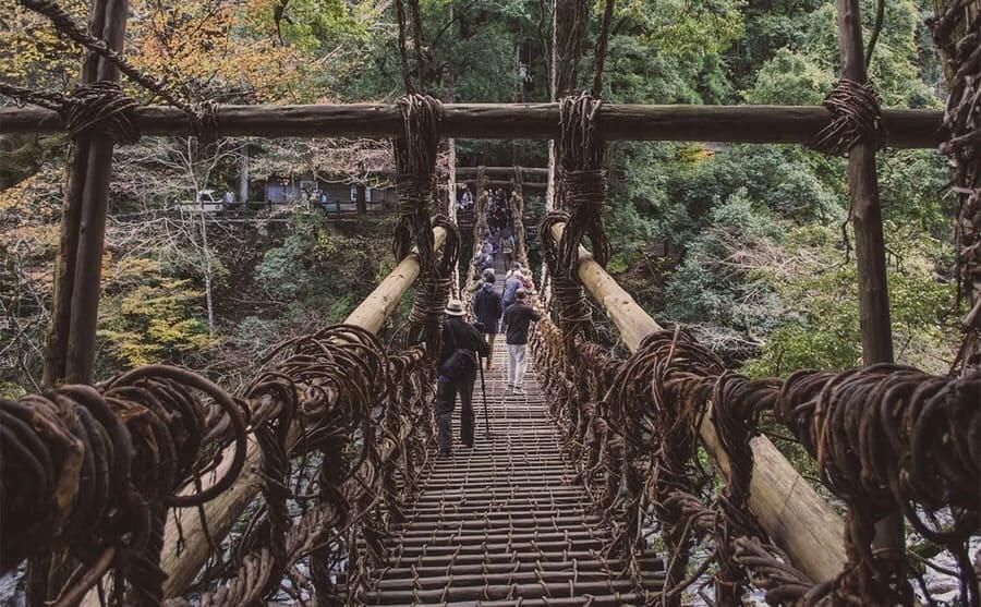 Tourists walking down the Kazurabashi Vine Bridge 