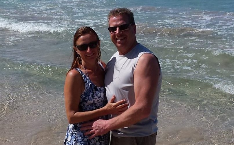 Michele and Dave posing on the beach together 