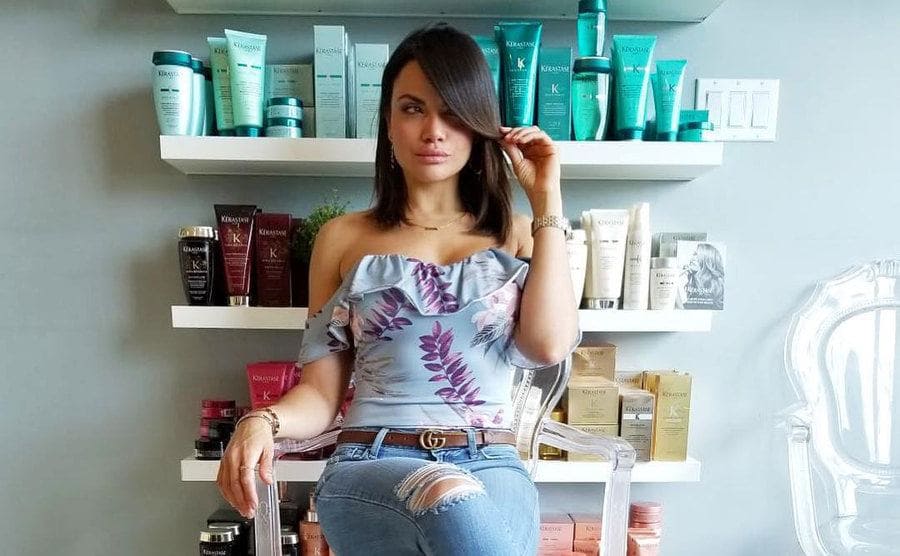 Samantha Sepulveda sitting in front of cosmetic products