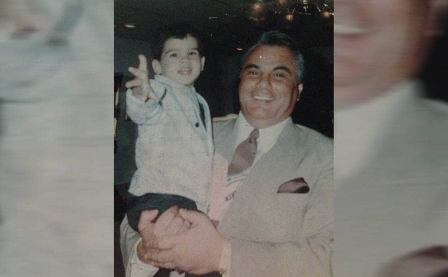 John Gotti holding his son Frankie in his arms 