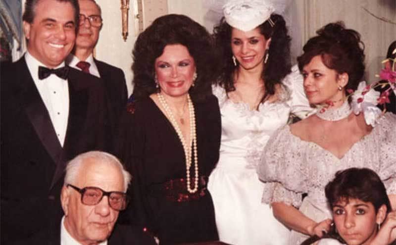Victoria Gotti standing hugging her family members on her wedding day