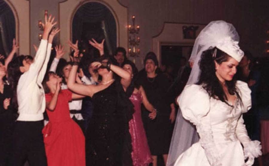 Victoria Gotti throwing her bridal bouquet to a group of young women at her wedding