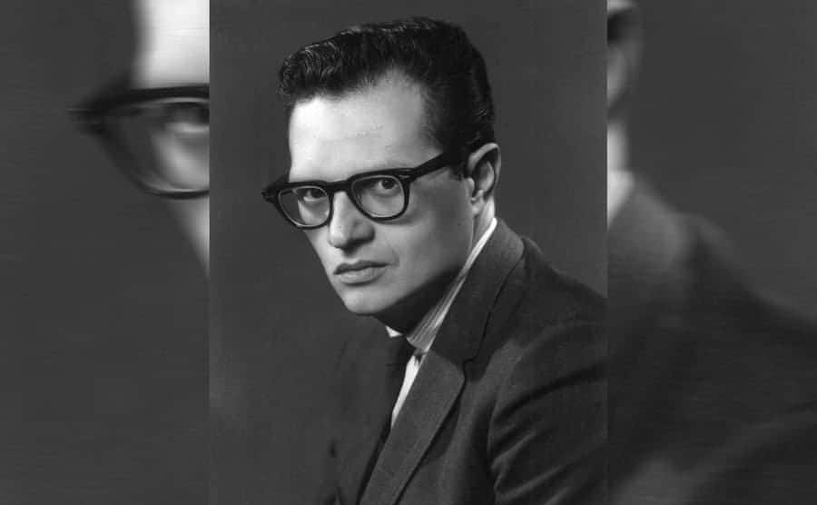 Larry King in an old high school portrait with black framed glasses