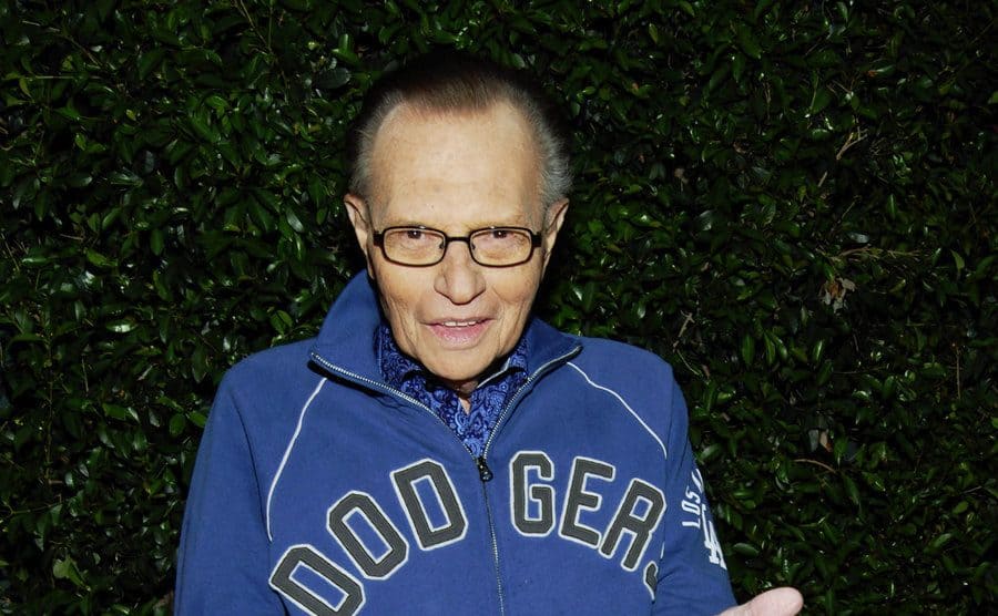 Larry King in a blue Dodgers sweater on the red carpet in 2009
