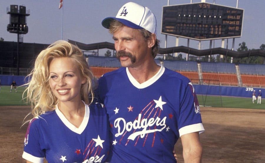 Pamela Anderson posing with Richard Dean Anderson at Dodgers stadium 