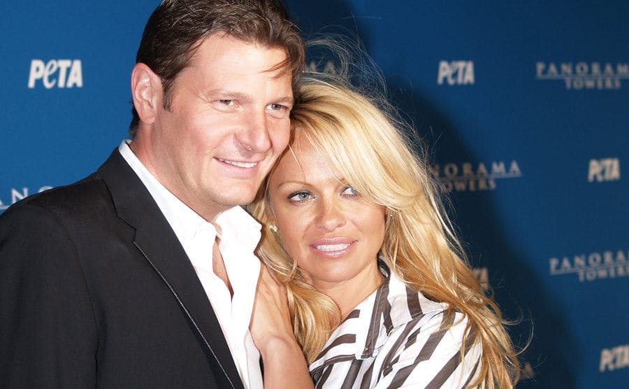 Laurence Hallier and Pamela Anderson posing on the red carpet 