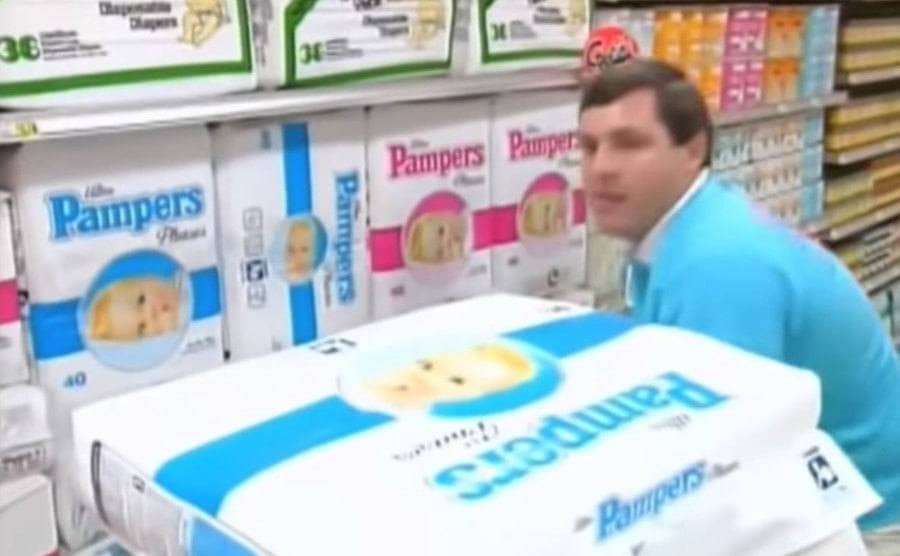 A contestant in the diaper section piling pampers into his cart 