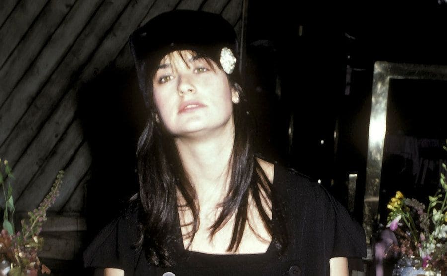Demi Moore in a beret at an event in 1986