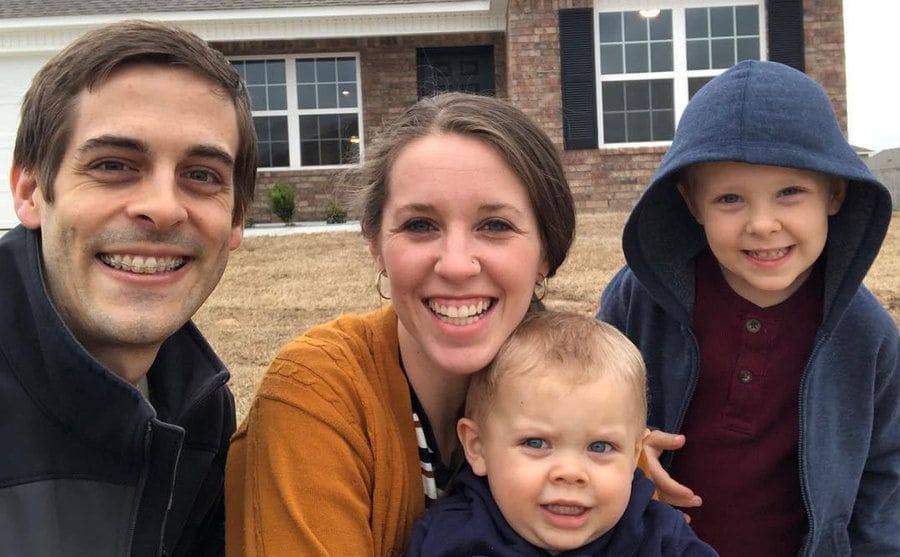 Jill Duggar with her husband and two boys outside their home.