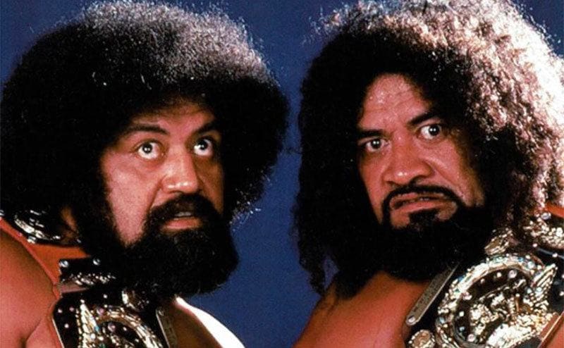 The Wild Samoans posing with their belts 