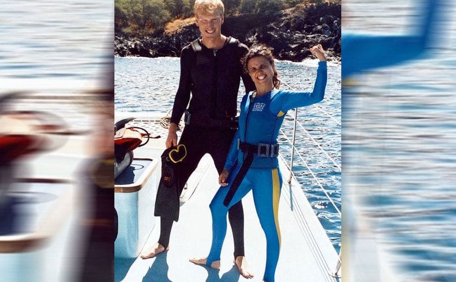 Brad Hall and Julia Louis Dreyfus in scuba gear on a boat 
