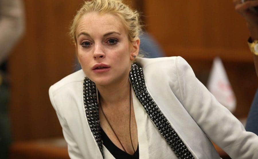 Lindsay Lohan sitting behind the defendants' table in court 