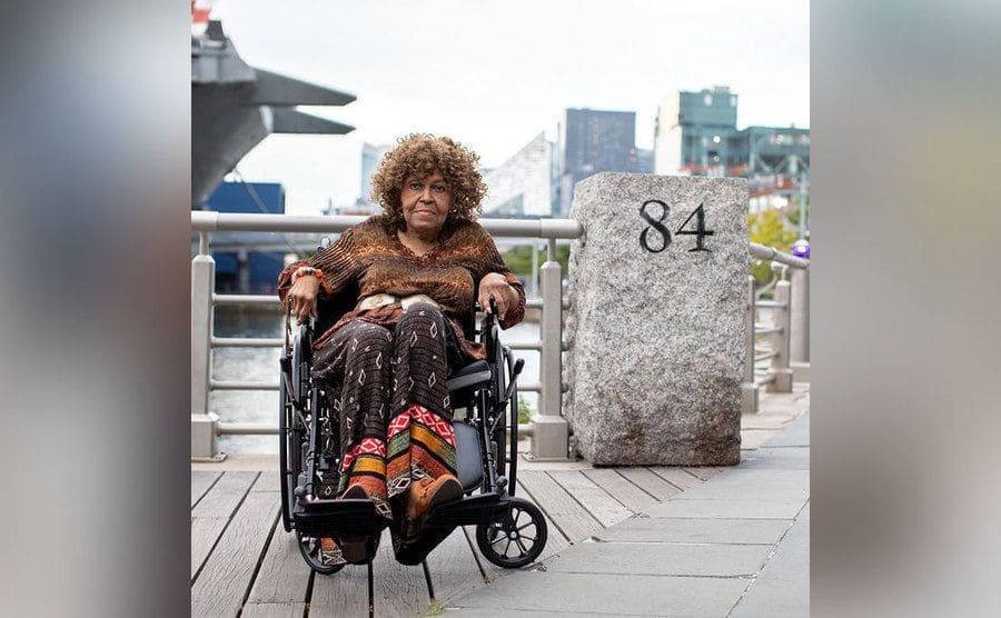 Stephanie sitting in her wheelchair on the docks. 
