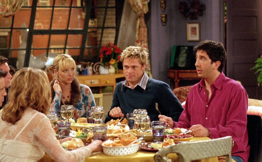Brad Pitt sitting around the table with the cast members of Friends 
