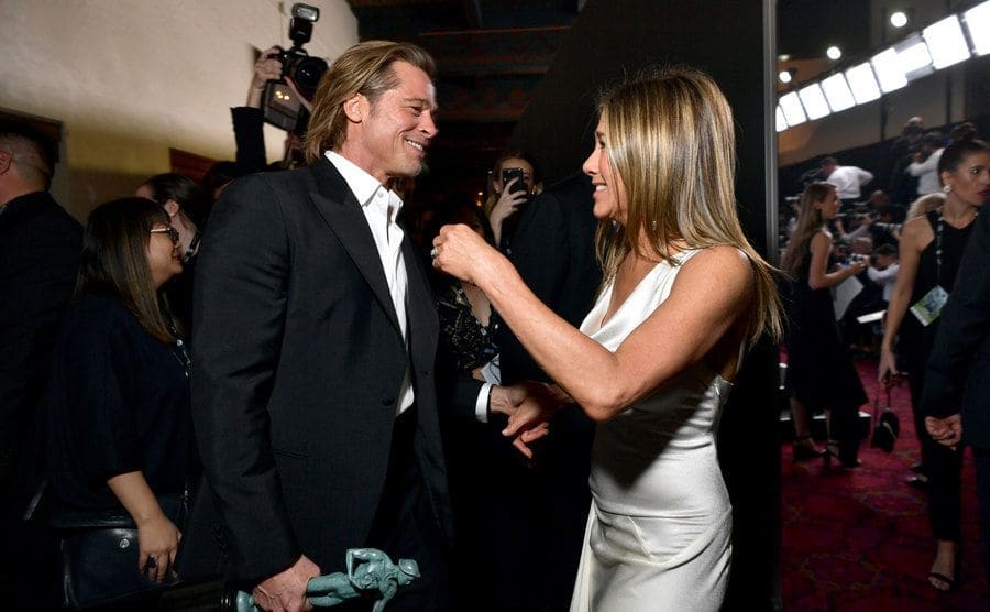 Jennifer Aniston and Brad Pitt greeting each other at an event in 2020 