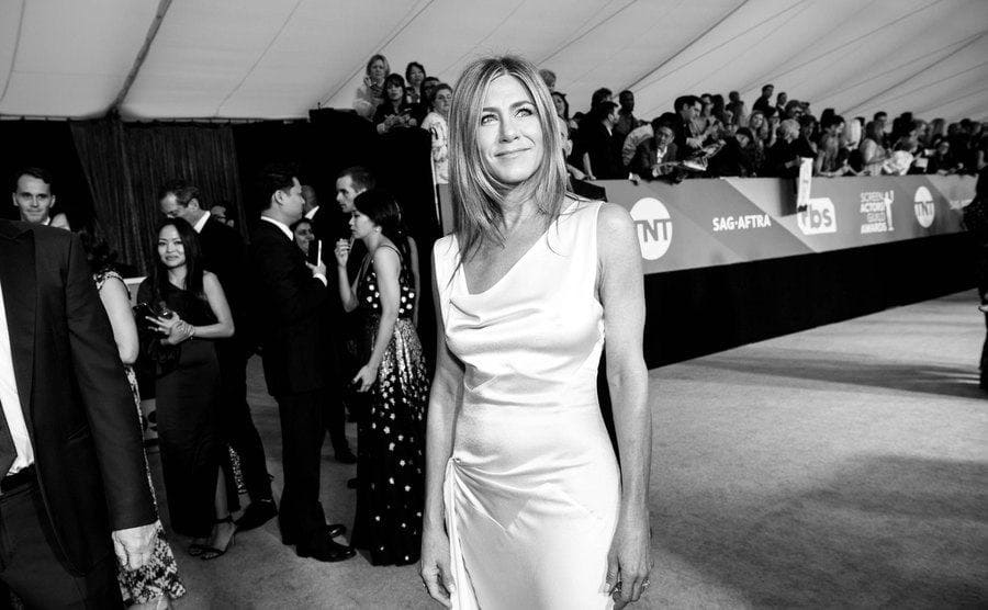 A black and white photograph of Jennifer Aniston on the red carpet 