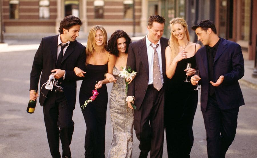 The cast of Friends walking down the street in a promotional photograph 